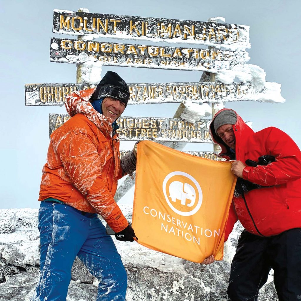John Mina and David Scheven atop Mount Kilimanjaro