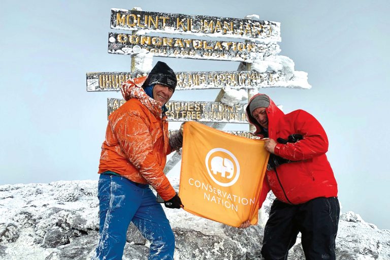 John Mina and David Scheven atop Mount Kilimanjaro