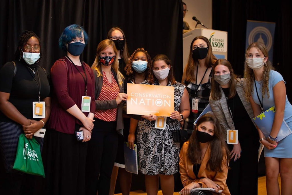 Conservation Nation Director of Education Elise Bernardoni standing with a group of students at George Mason University's Washington Youth Summit on the Environment