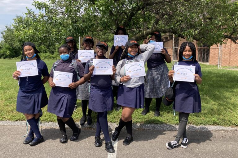 Washington School for Girls students holding certificates after completing Conservation Nation education program