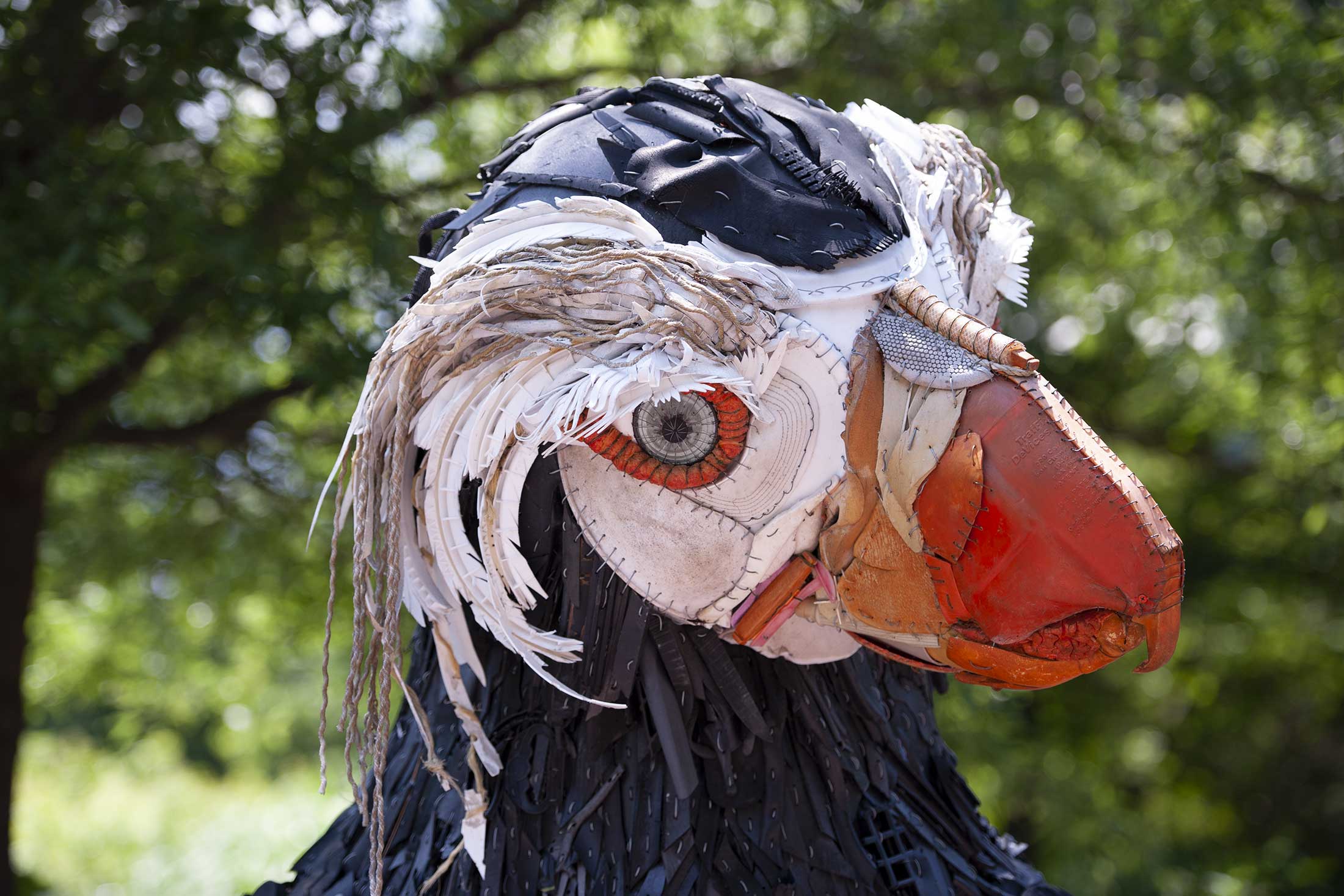 a sculpture of a puffin created by trash found on beaches