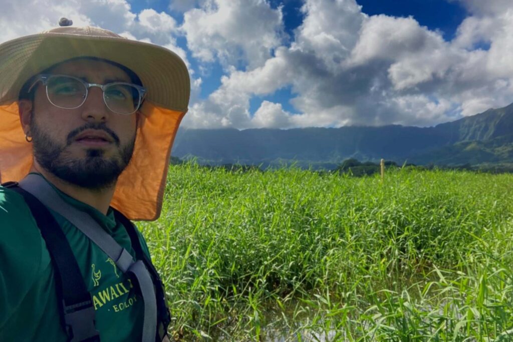 Conservation Nation grantee Jaime Botet Rodrigues near a marsh with mountains in the background