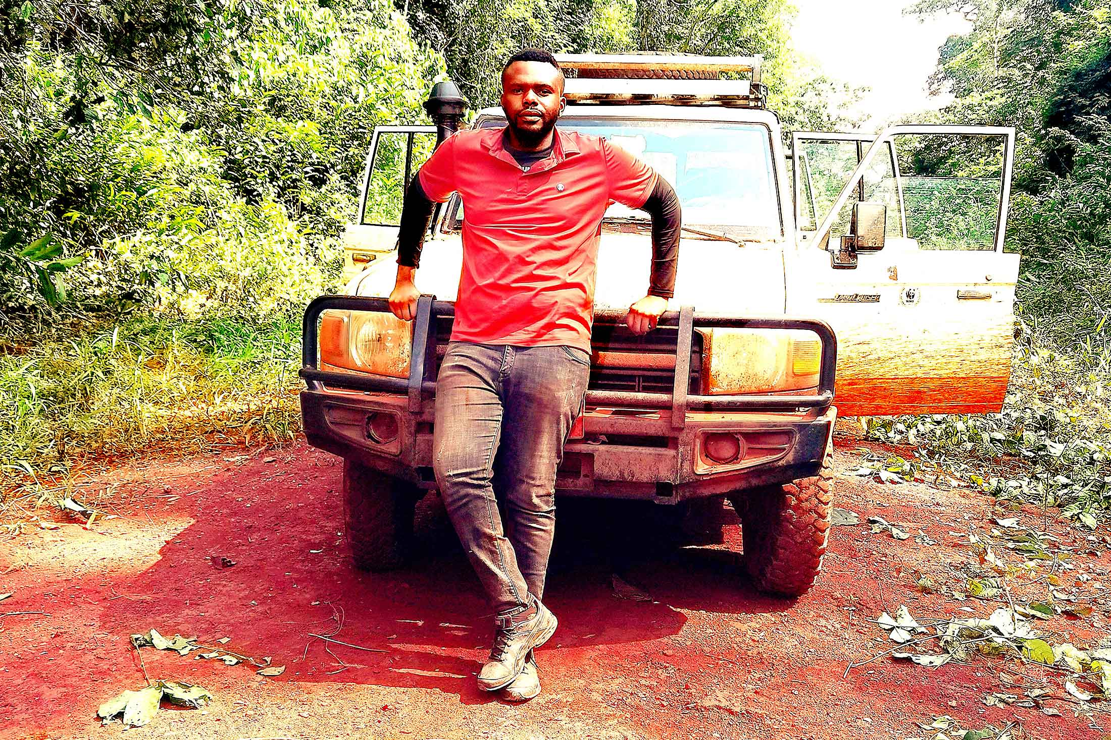 Conservation Nation grantee Lotanna Nneji leaning against a white SUV