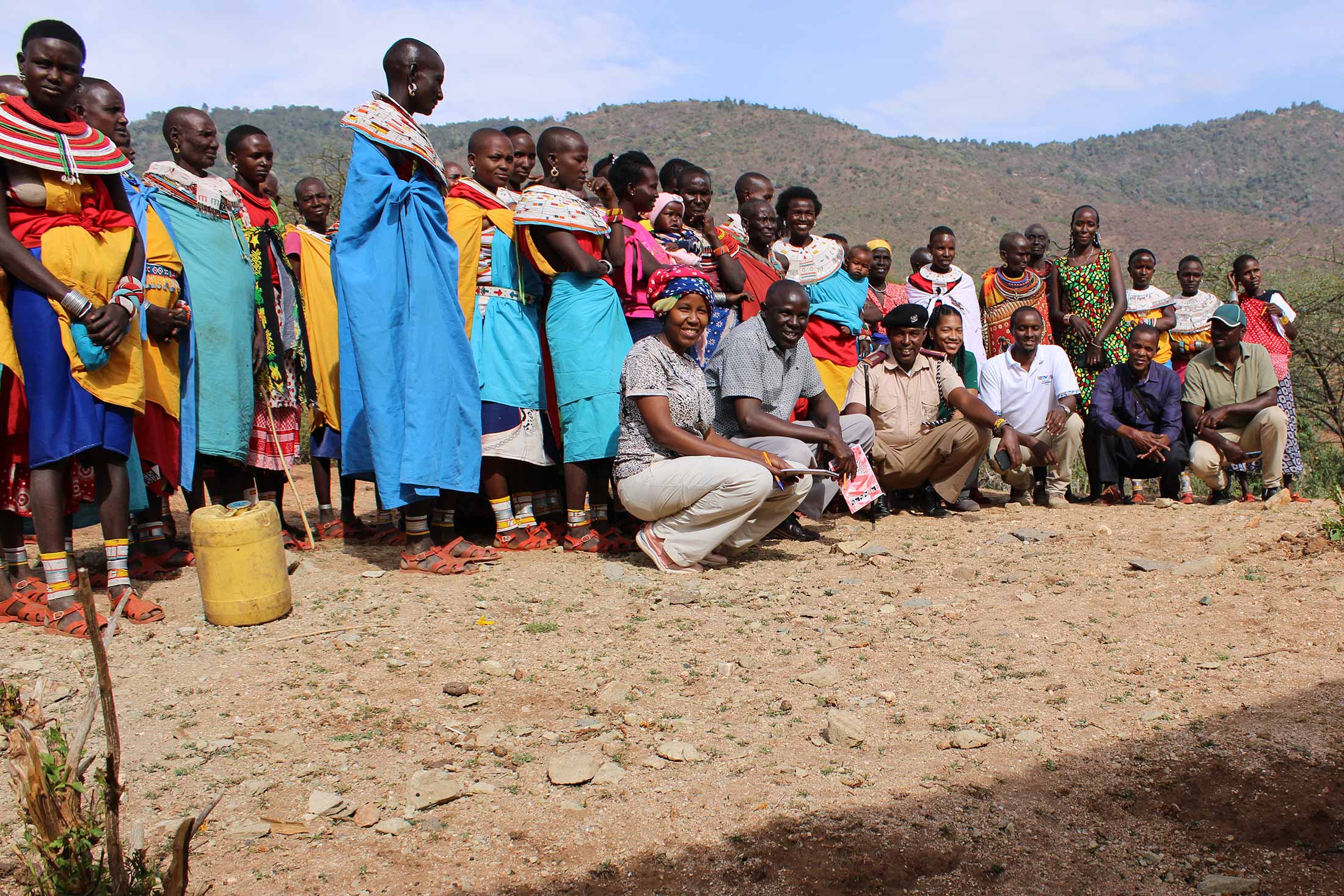 a group of community workshop participants in Kenya wearing colorful clothing