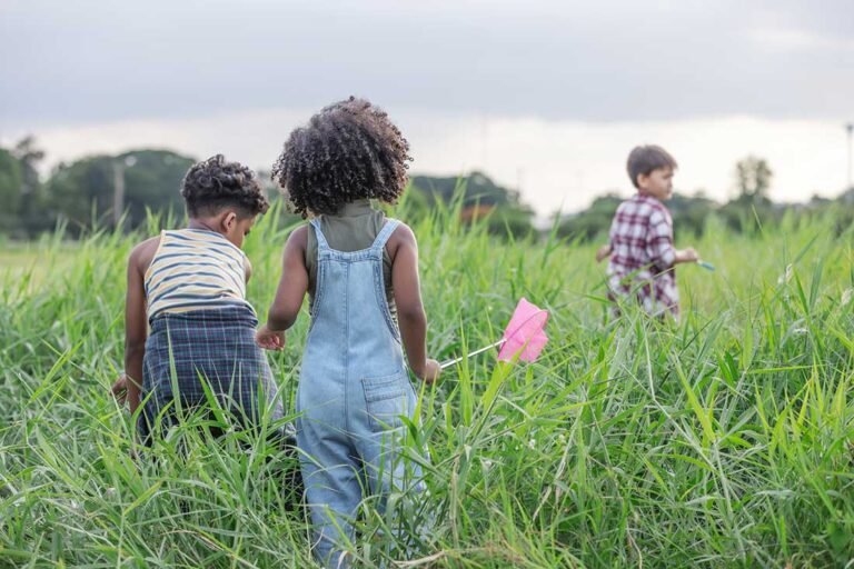 kids playing in tall grass