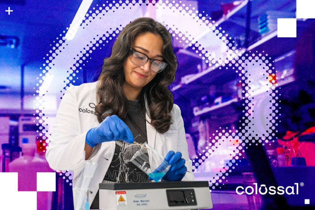 a female scientist wearing safety glasses, a lab coat, and gloves holding a beaker with blue liquid in a laboratory